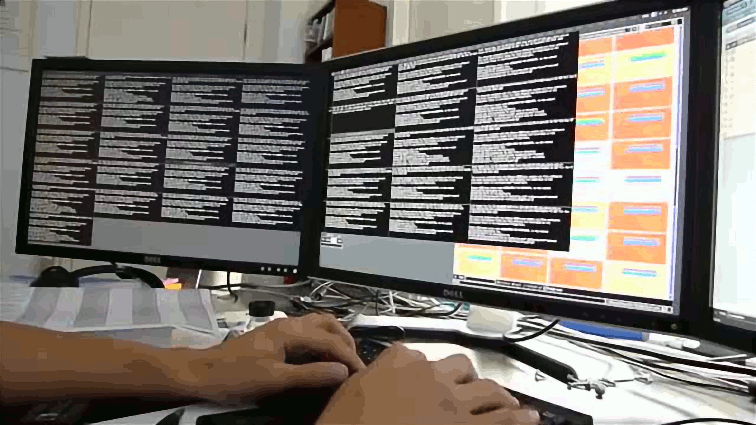 Hands typing on a keyboard below three screens displaying 36 small ssh terminals